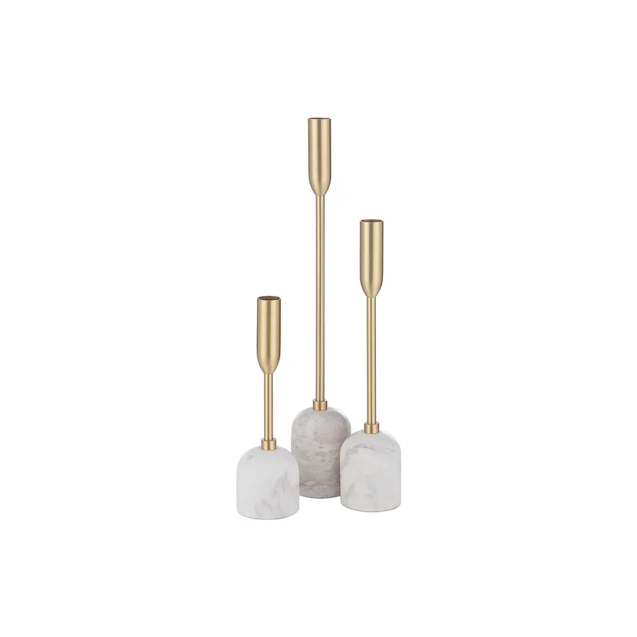 Three gold-tone taper candlesticks with cylindrical marble bases in white and light gray, arranged in ascending height on a plain white background.
