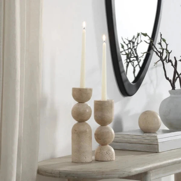 Stack of beige stone candle holders on a white background