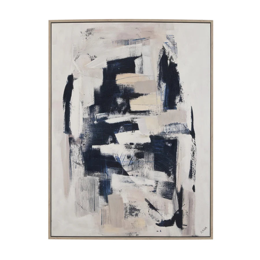 An abstract framed painting featuring layered brushstrokes in black, navy, beige, and white on a light background, enclosed in a thin metallic frame.